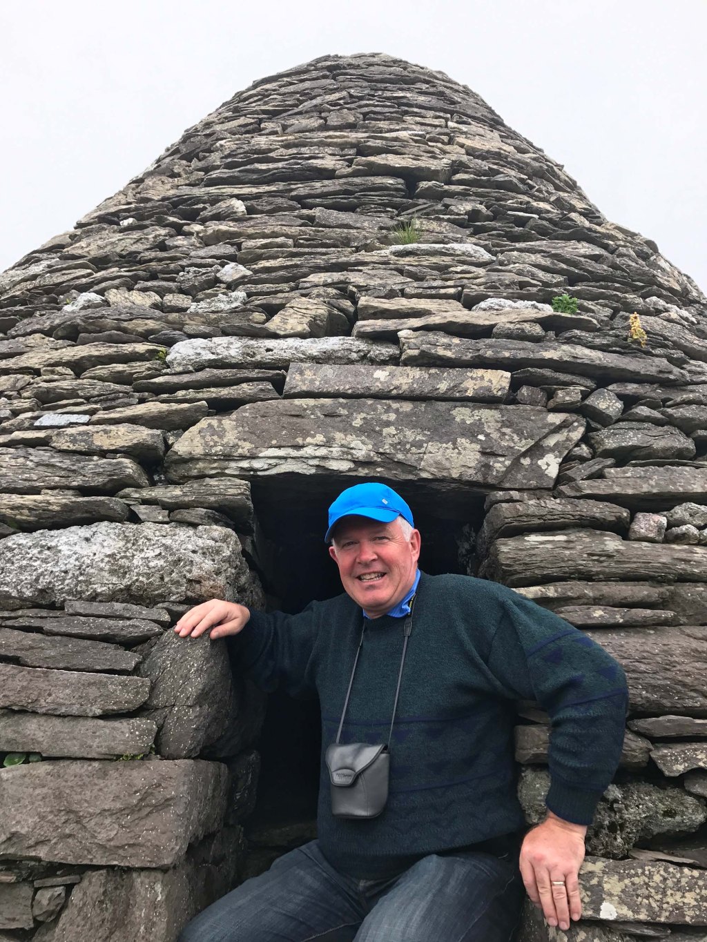 David V. Power at a rock structure shaped like a hut or cone.